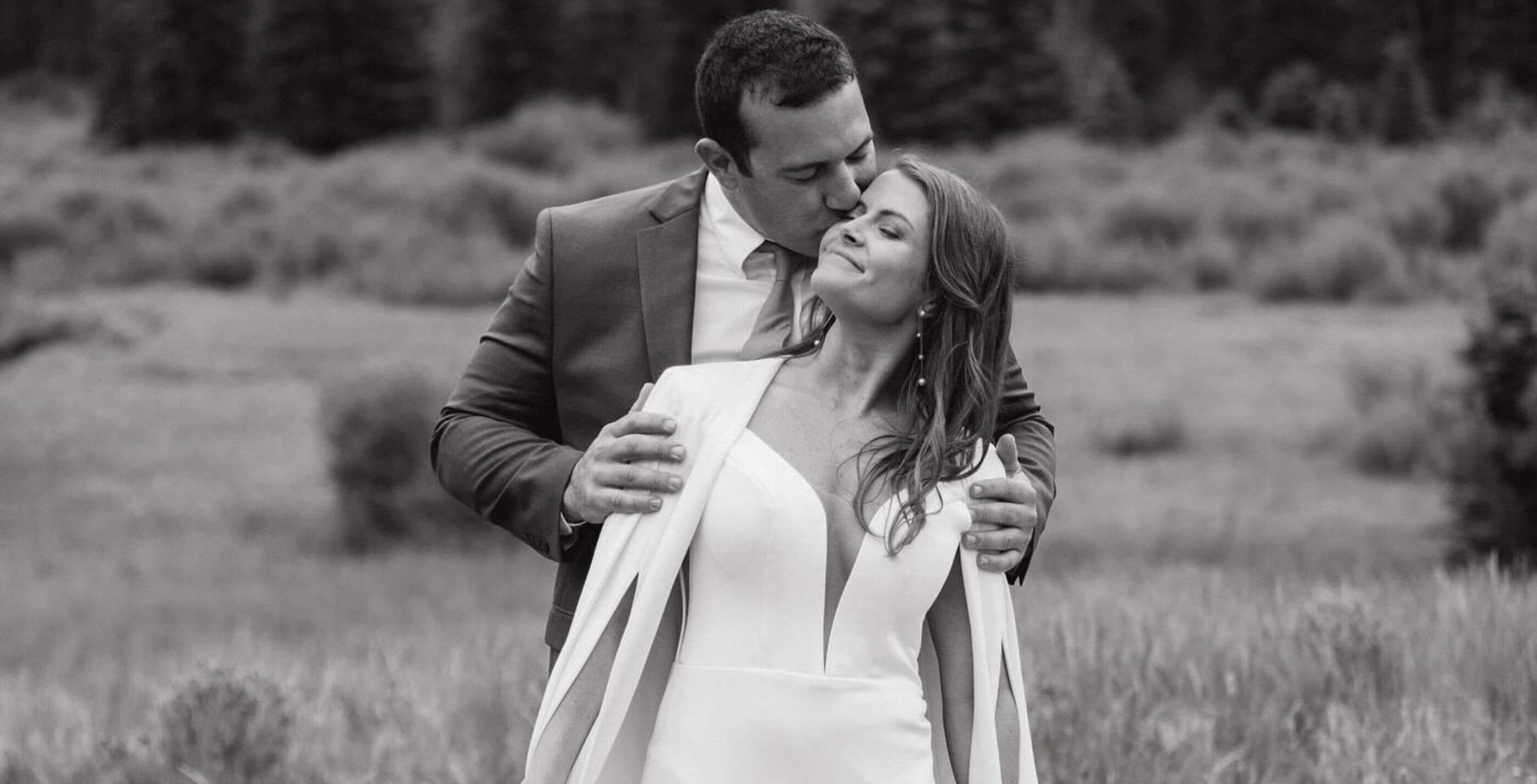 Сouple wearing a white gown and a gray suit